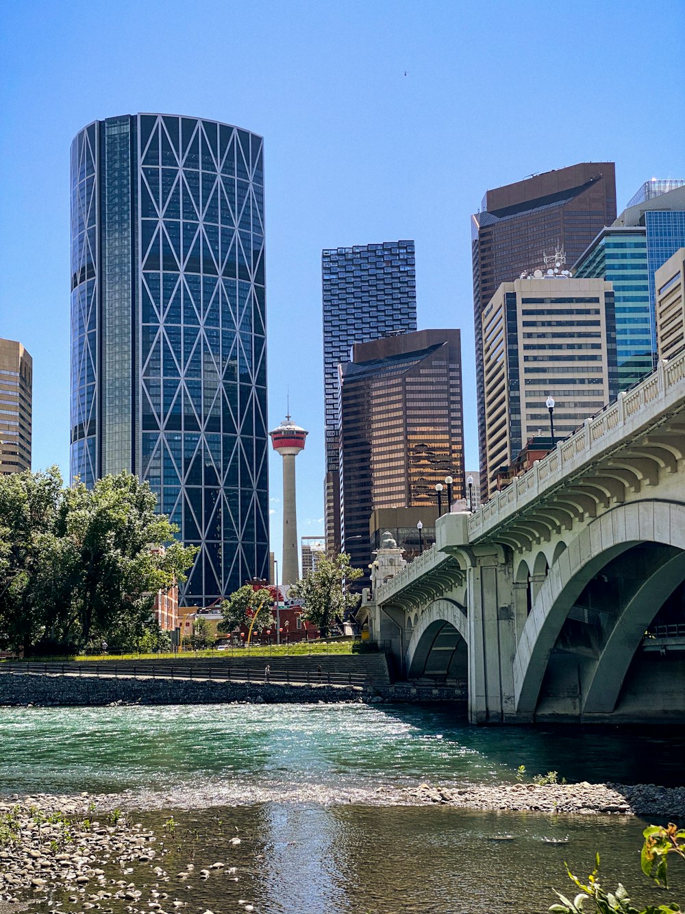 white bridge over river near city buildings during daytime