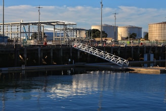 Industrial storage tanks connected to a dock in a free trade zone.