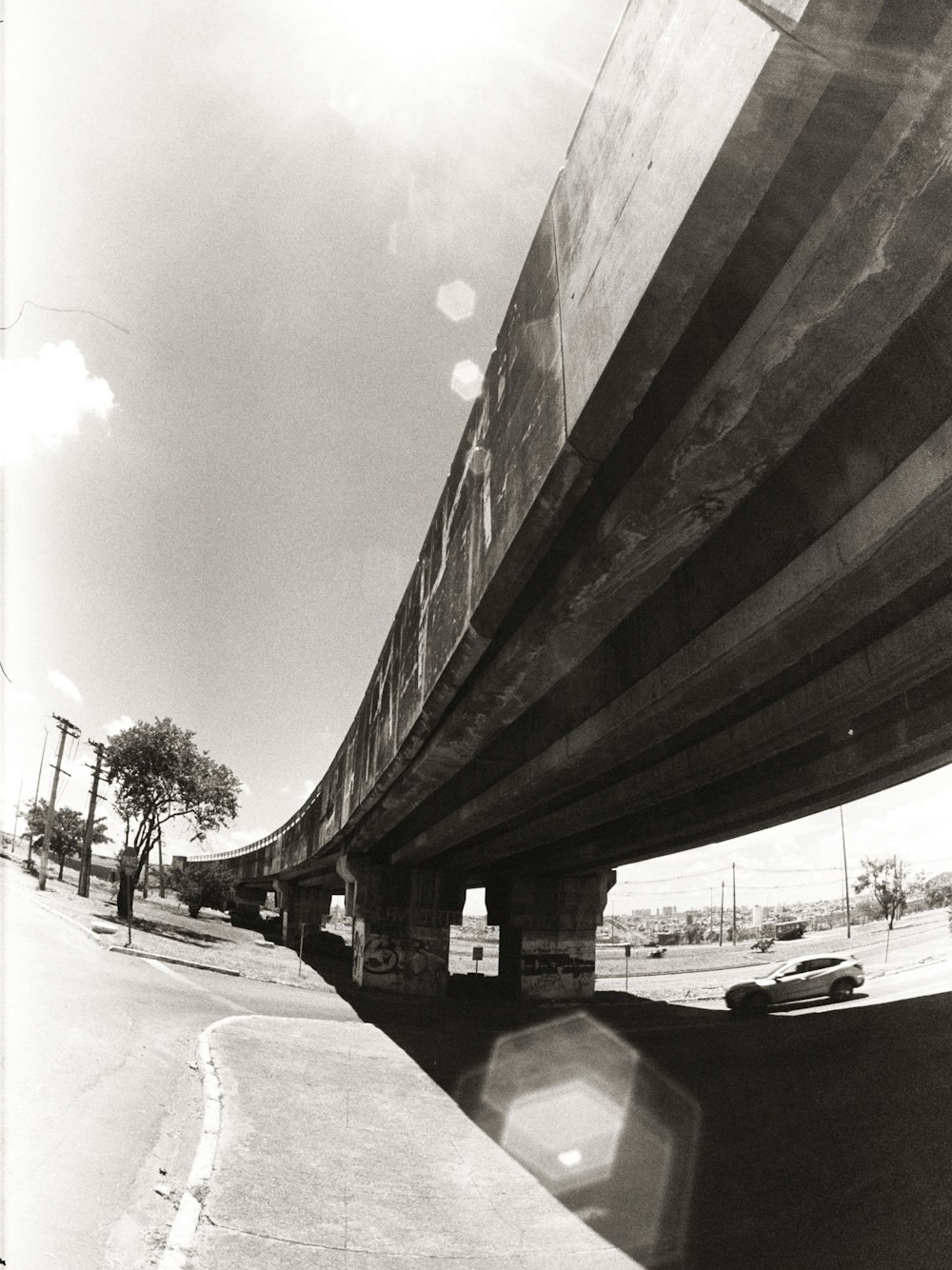 grayscale photo of a man walking on a street