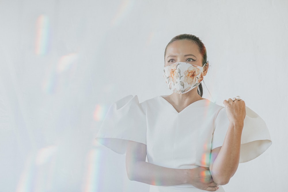 woman in white v neck shirt with white mask