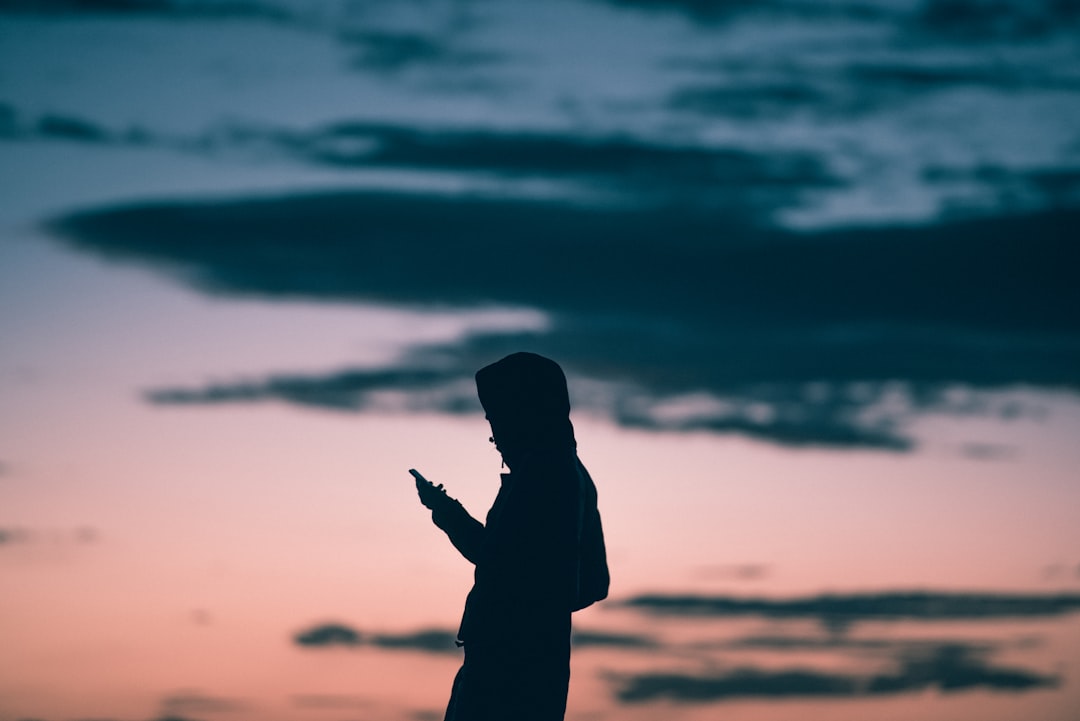 silhouette of man standing during sunset