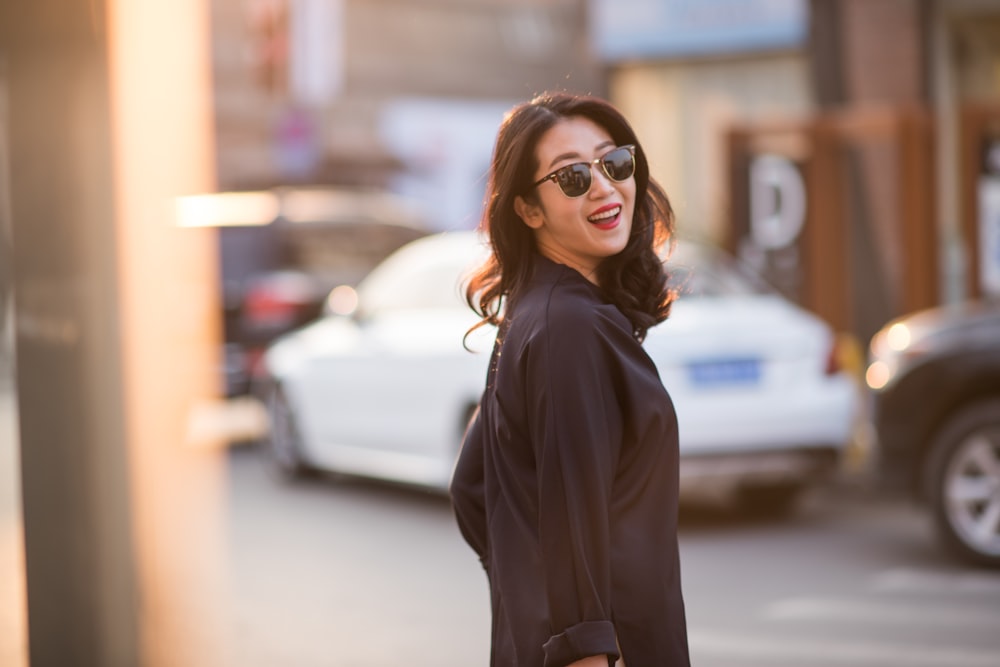 woman in black long sleeve shirt wearing brown sunglasses