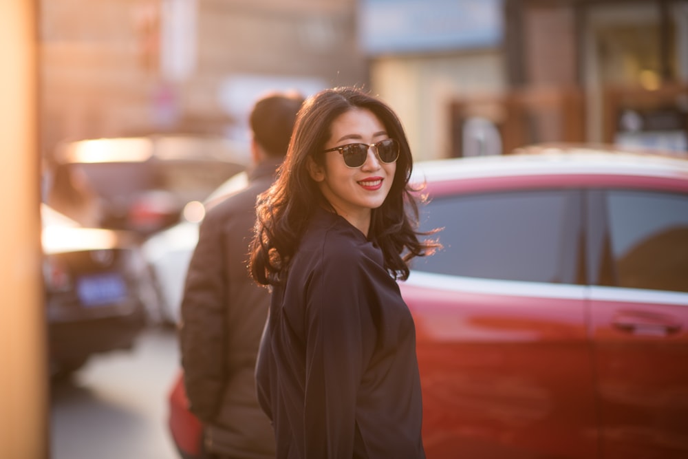 woman in black coat wearing black framed eyeglasses