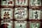 Several traditional sake barrels are stacked in a symmetrical arrangement. Each barrel is adorned with Japanese calligraphy and symbols, highlighting intricate designs and various insignias representative of sake breweries.