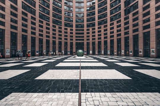 brown and white concrete building in European Parliament France