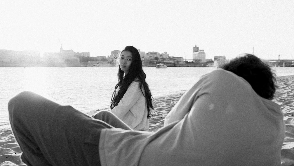 grayscale photo of woman in long sleeve shirt