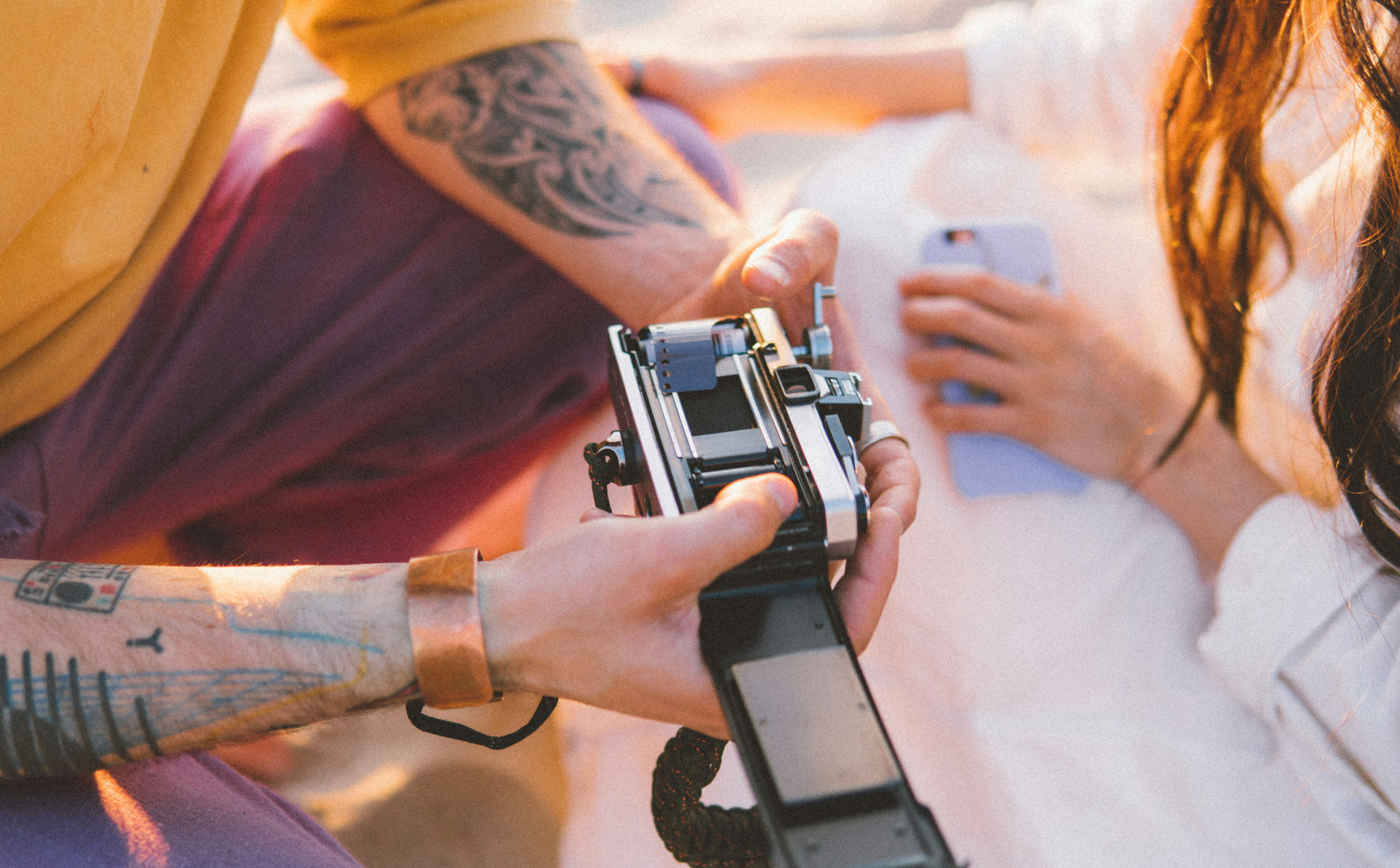 person holding black and silver camera