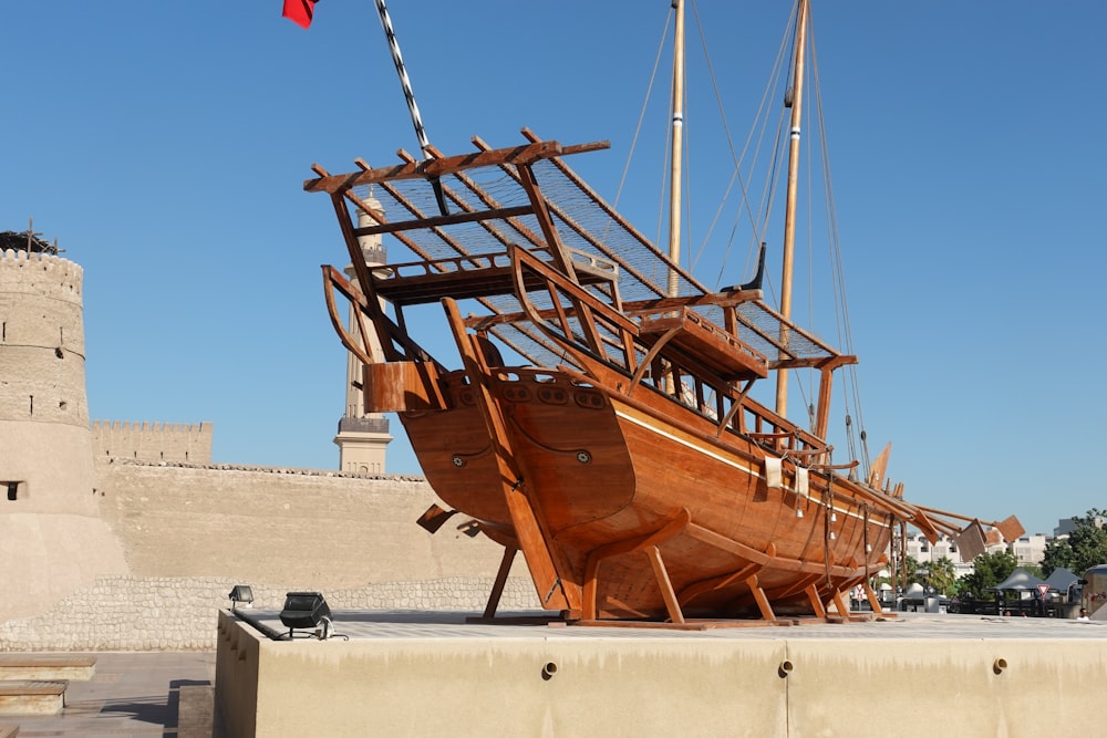 brown ship on white sand during daytime