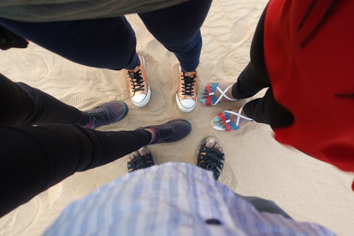 person in black pants and black and white sneakers