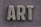 The word 'ART' is carved in a textured, concrete-like material, with rough, brush-stroke patterns covering the surface. It is set against a slate grey, wooden textured background.