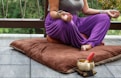 woman in purple dress sitting on gray couch