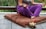 woman in purple dress sitting on gray couch