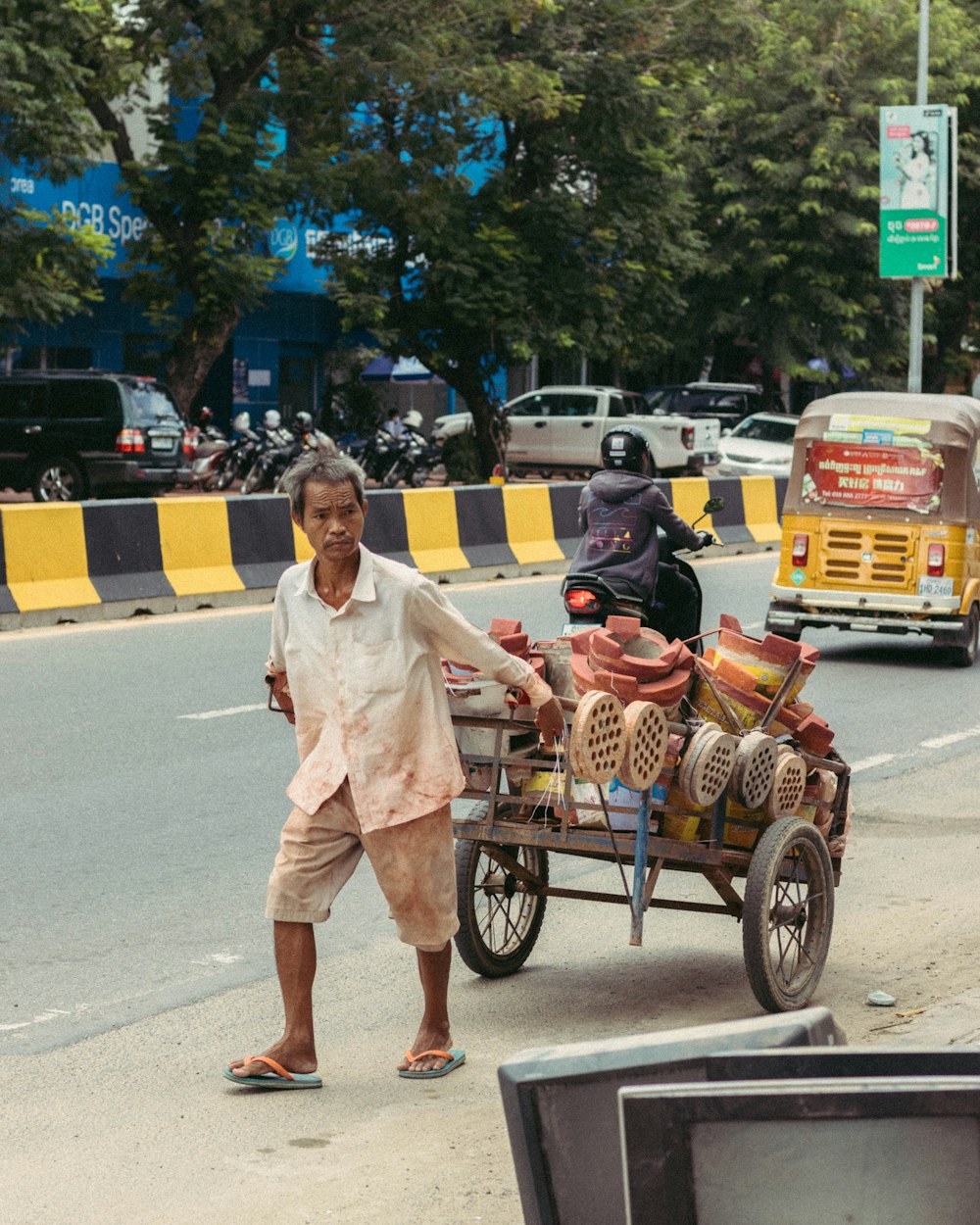 man and woman in white dress riding on brown wooden cart on road during daytime