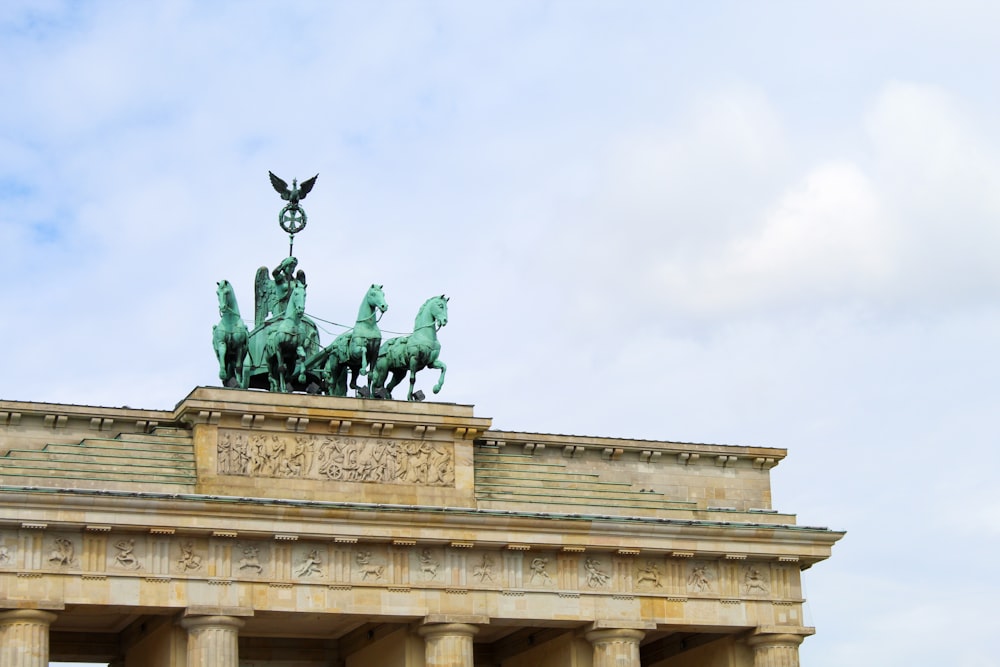 man riding horse statue under white sky during daytime