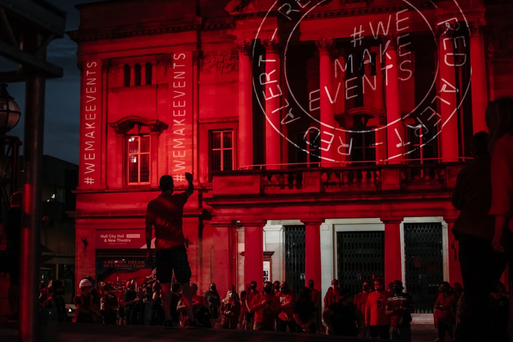 people sitting on chair near red building during daytime