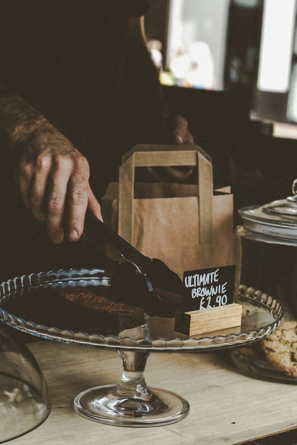 person holding black and brown wooden box