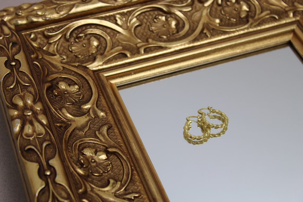 gold cross on brown wooden frame