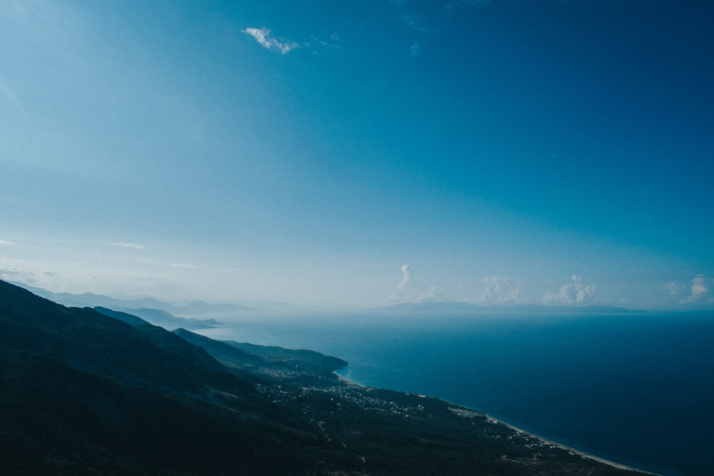 aerial view of mountains and body of water during daytime