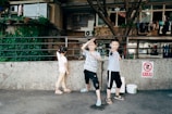 Children playing near a balcony with protective safety nets.