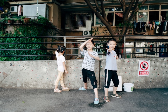 Children playing safely behind a balcony safety net.