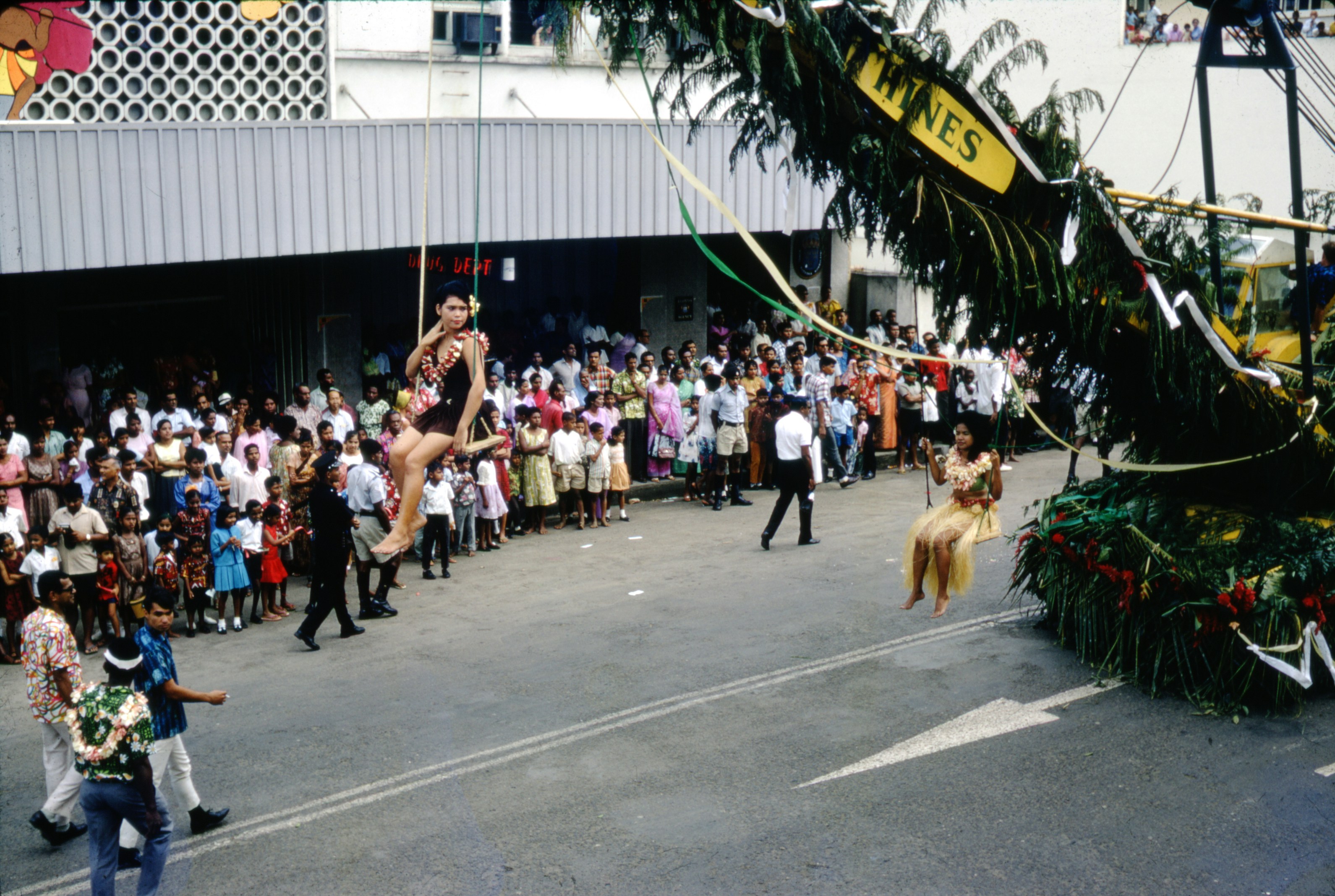 people walking on street during daytime, fiji, hibiscus festival, floats, 1960s, 60s, old photos, scanned photos, digitised photos, viti levu, suva, parade, celebration,