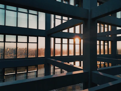 A sleek, modern luxury residence bathed in warm golden light at sunset.