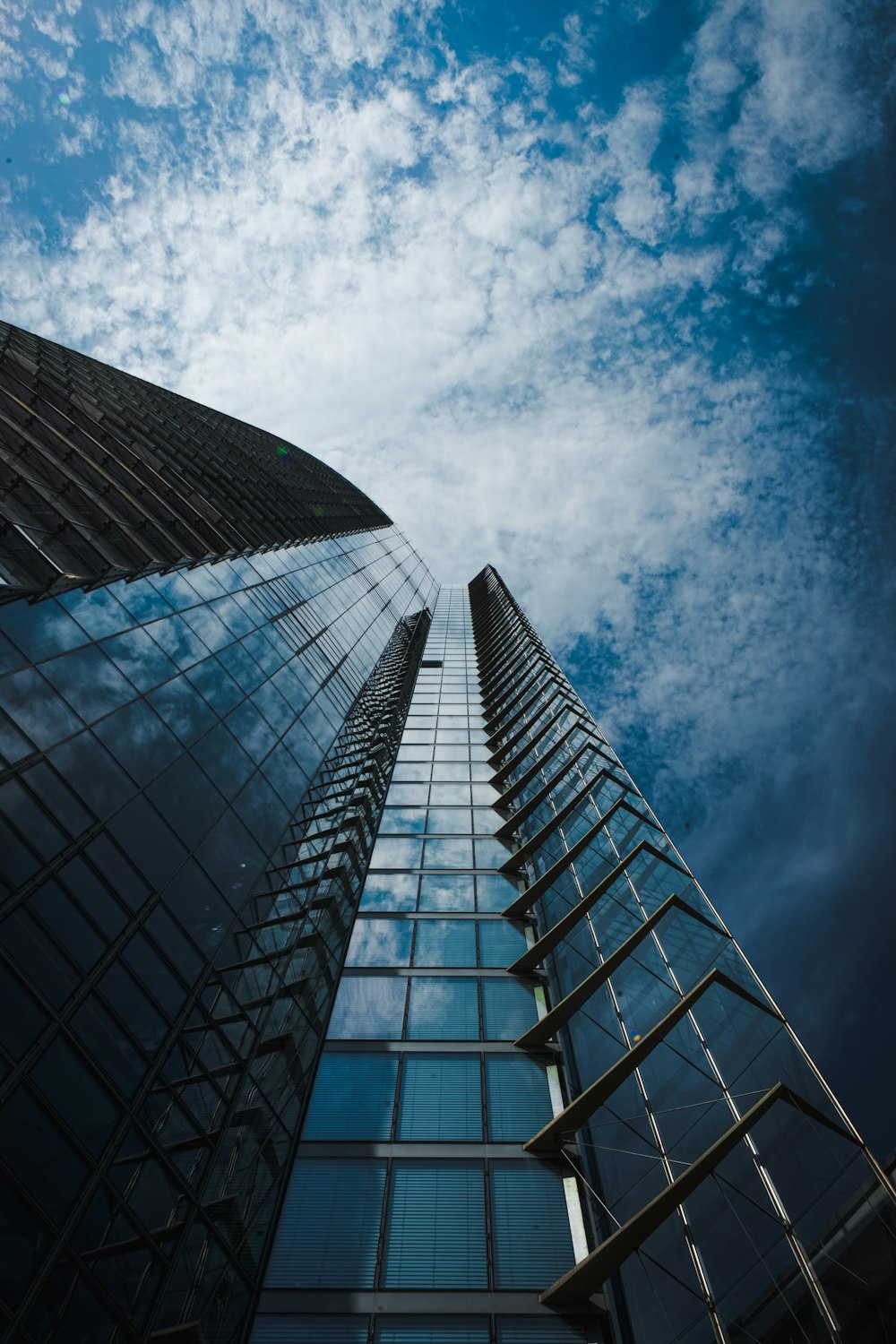 low angle photography of high rise building under blue sky