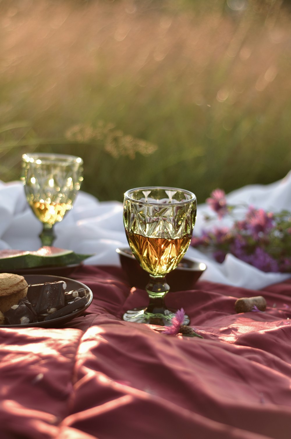 clear wine glass on red textile