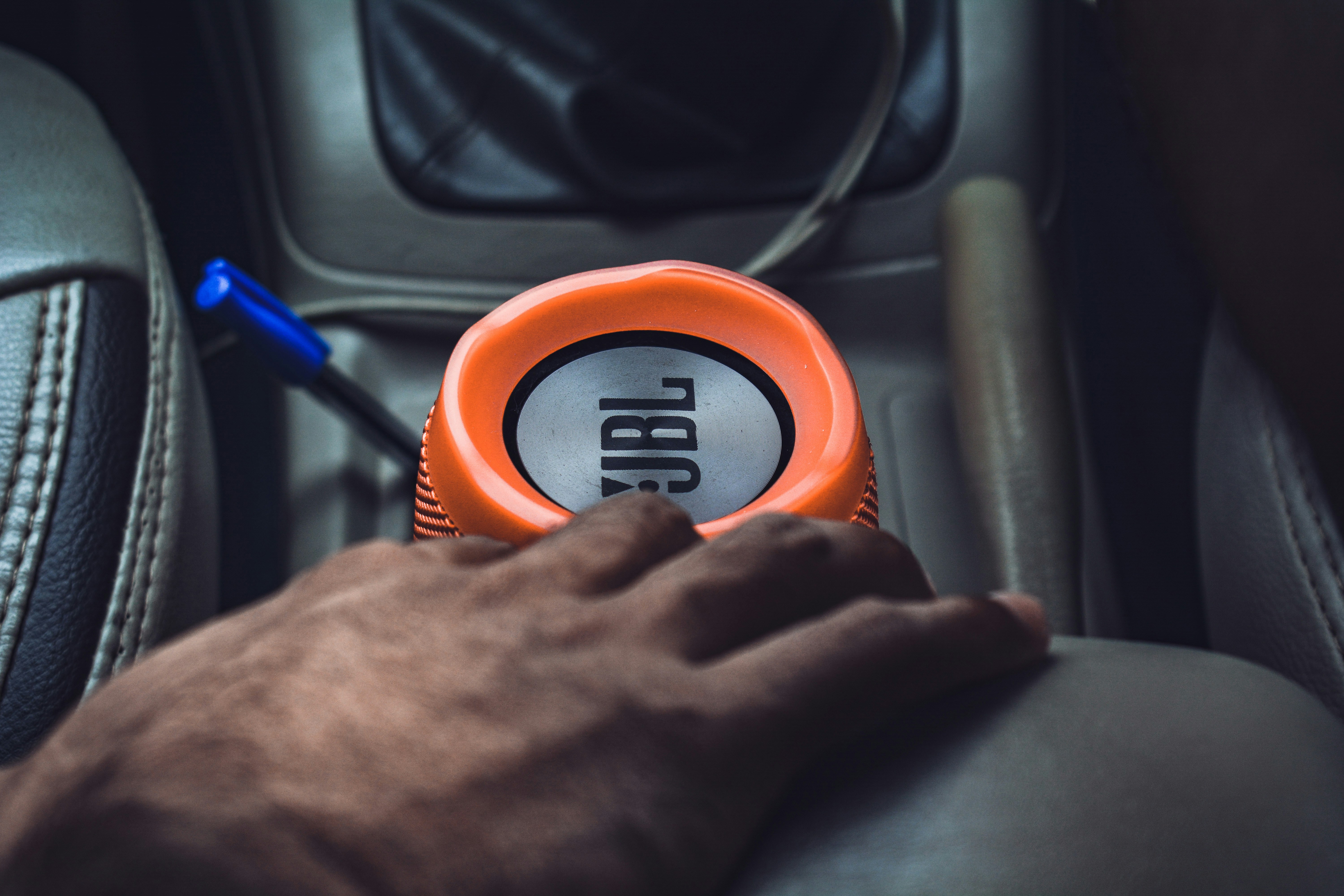 Driver reviewing a car maintenance checklist while inspecting under the hood