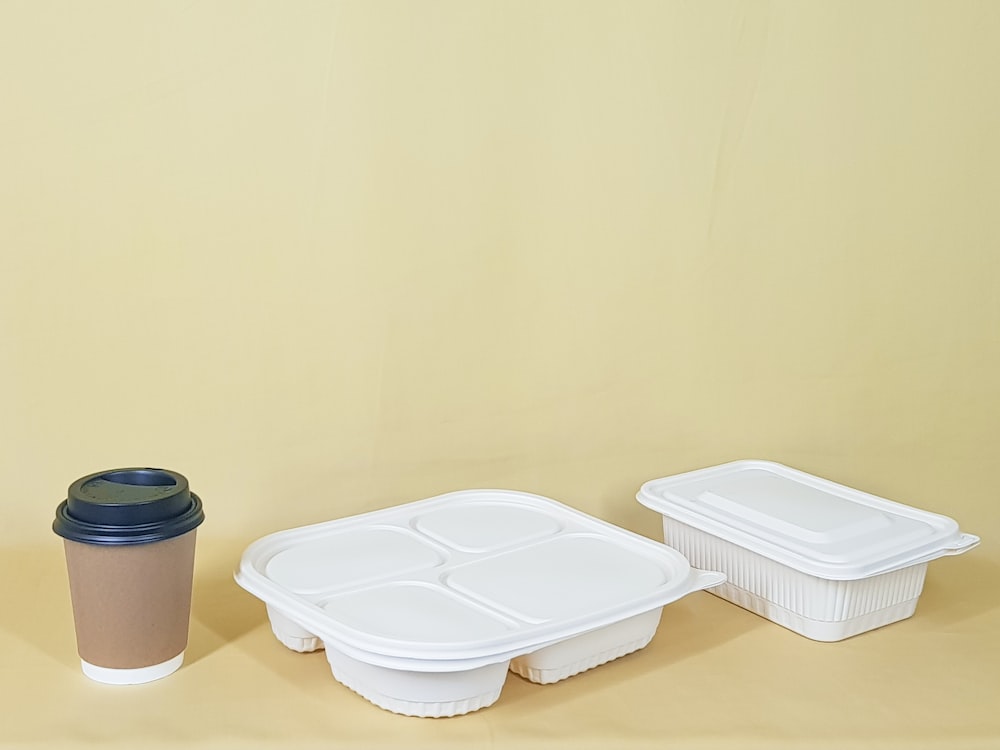 white plastic container on brown wooden table