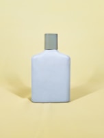 white and black bottle on yellow table