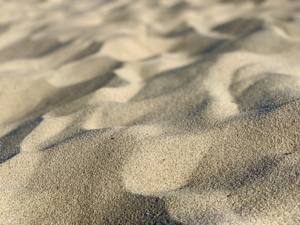 brown sand with footprints during daytime