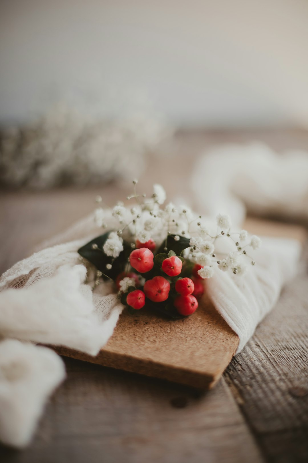 white and red rose bouquet on brown wooden table