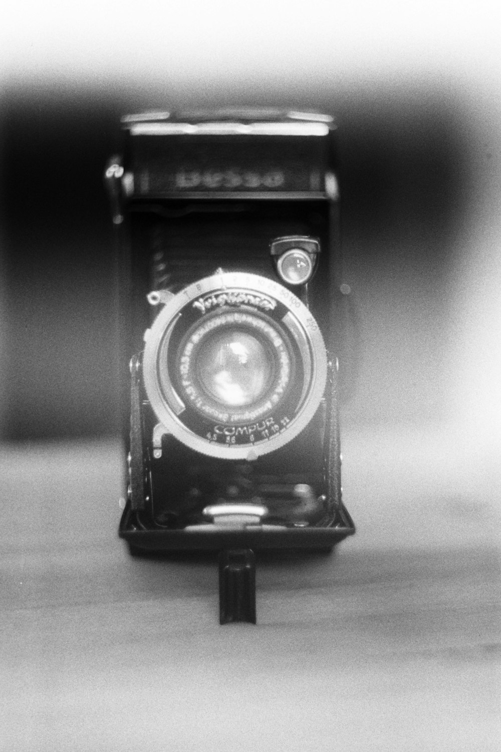 black and silver camera on brown wooden table