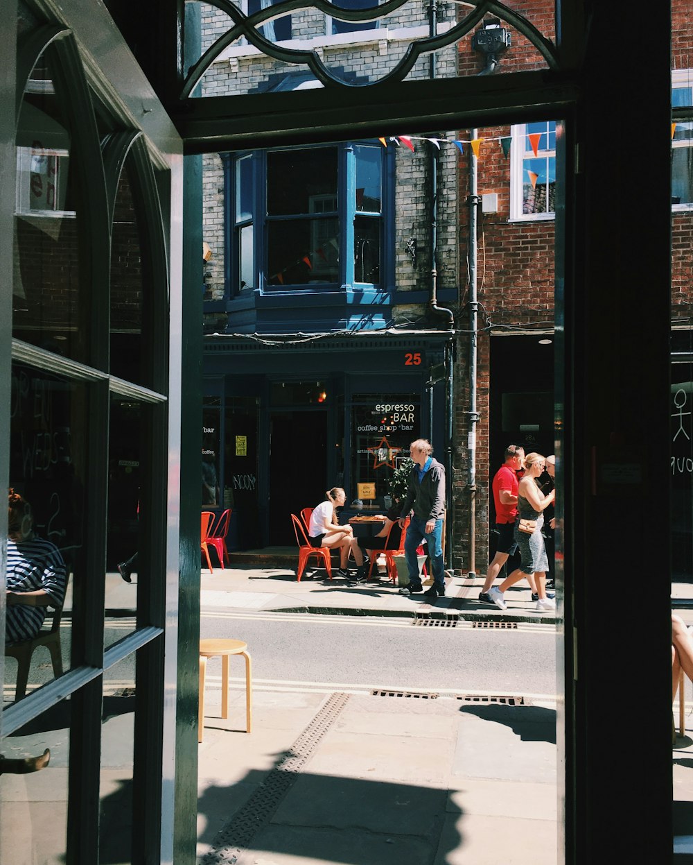 people sitting on bench in front of store during daytime