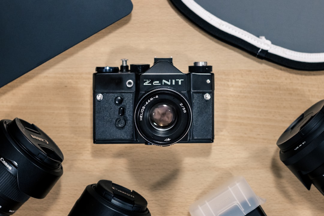 black nikon dslr camera on brown wooden table