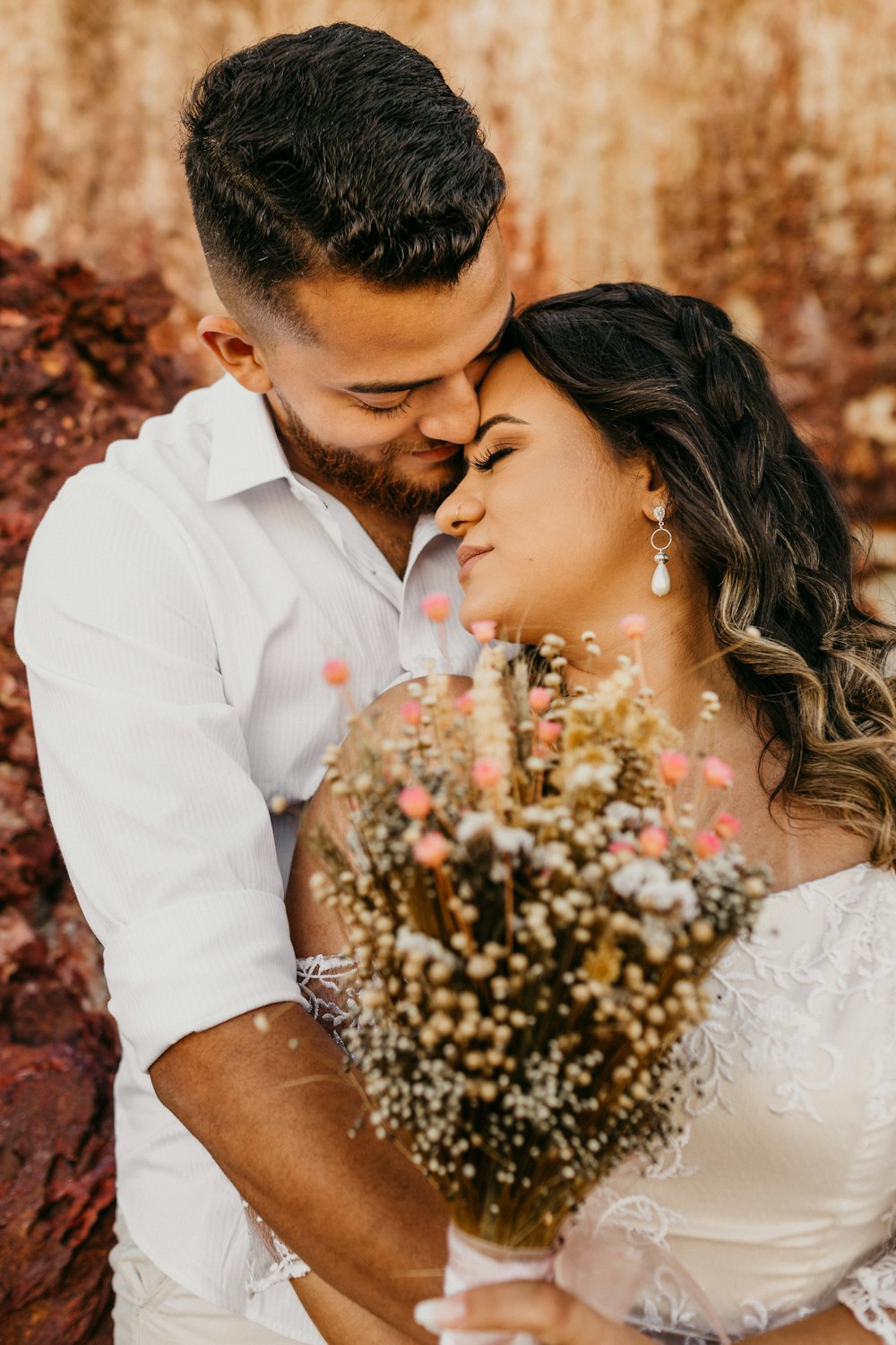 man in white dress shirt kissing womans hand