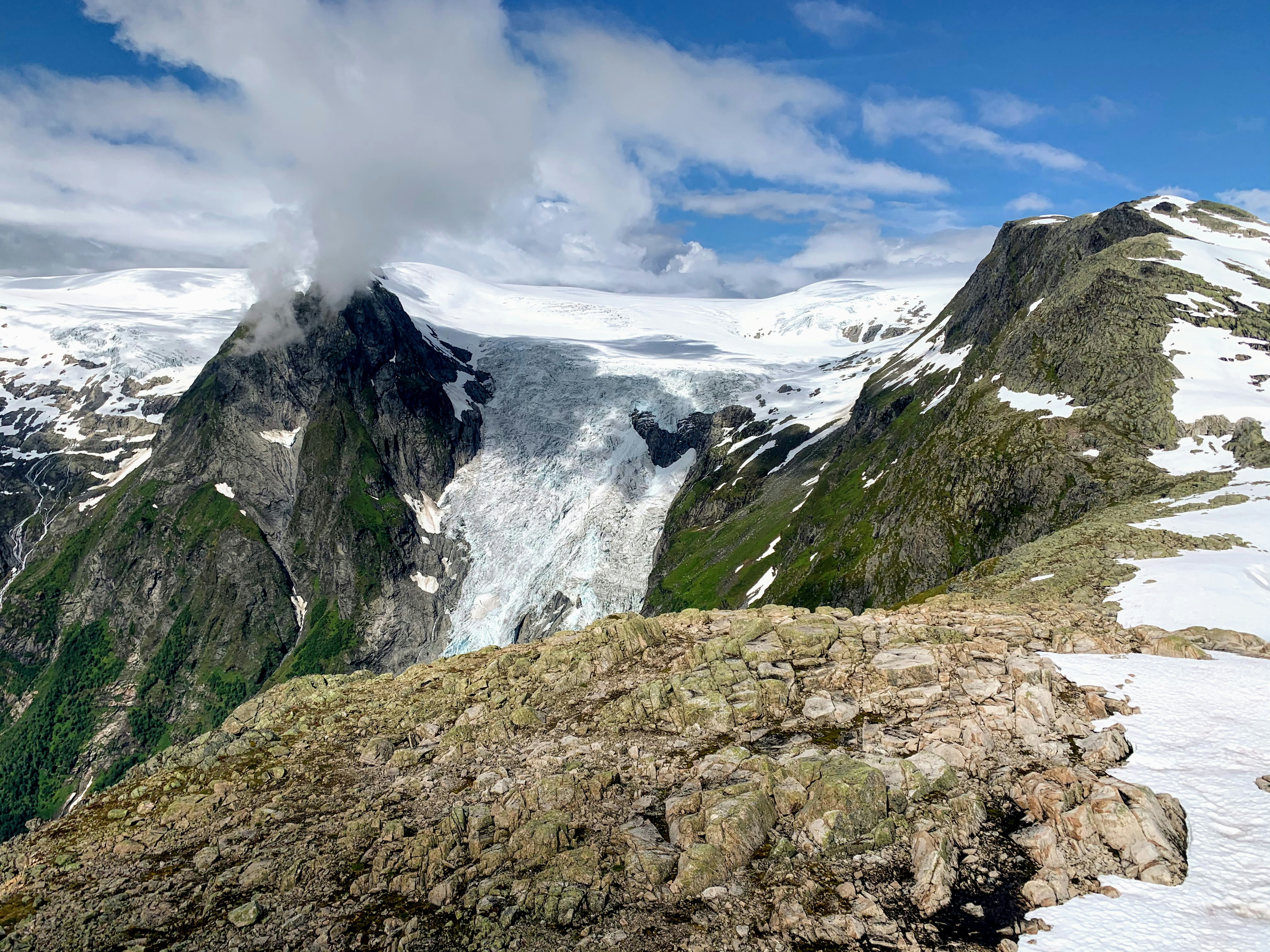 green and gray mountain under white clouds and blue sky during daytime