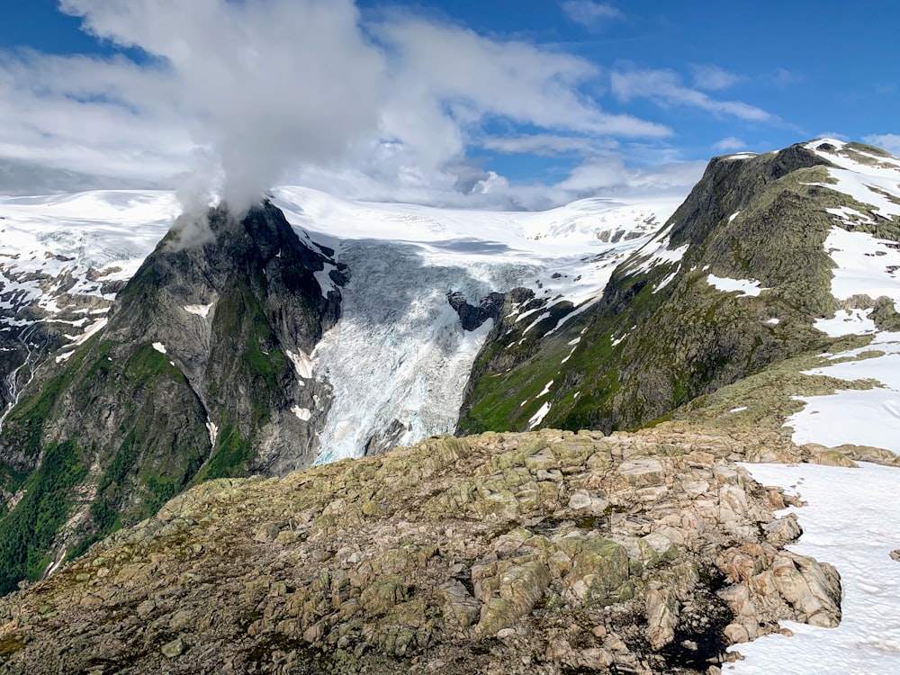 green and gray mountain under white clouds and blue sky during daytime