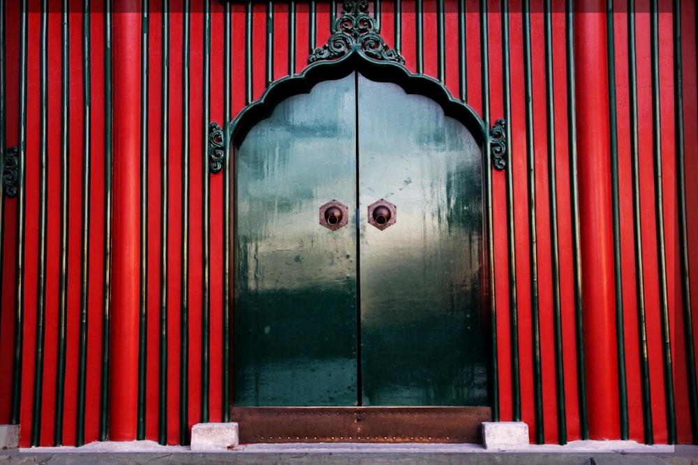green wooden door with red and white wooden door