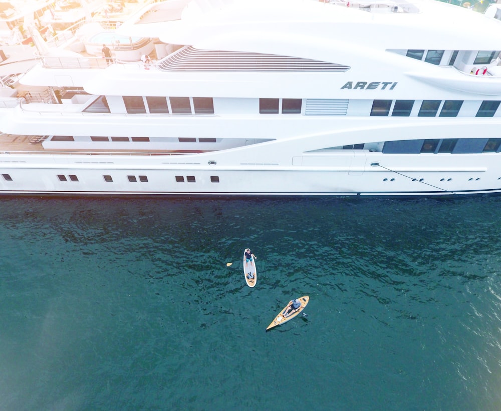 white and blue boat on body of water during daytime