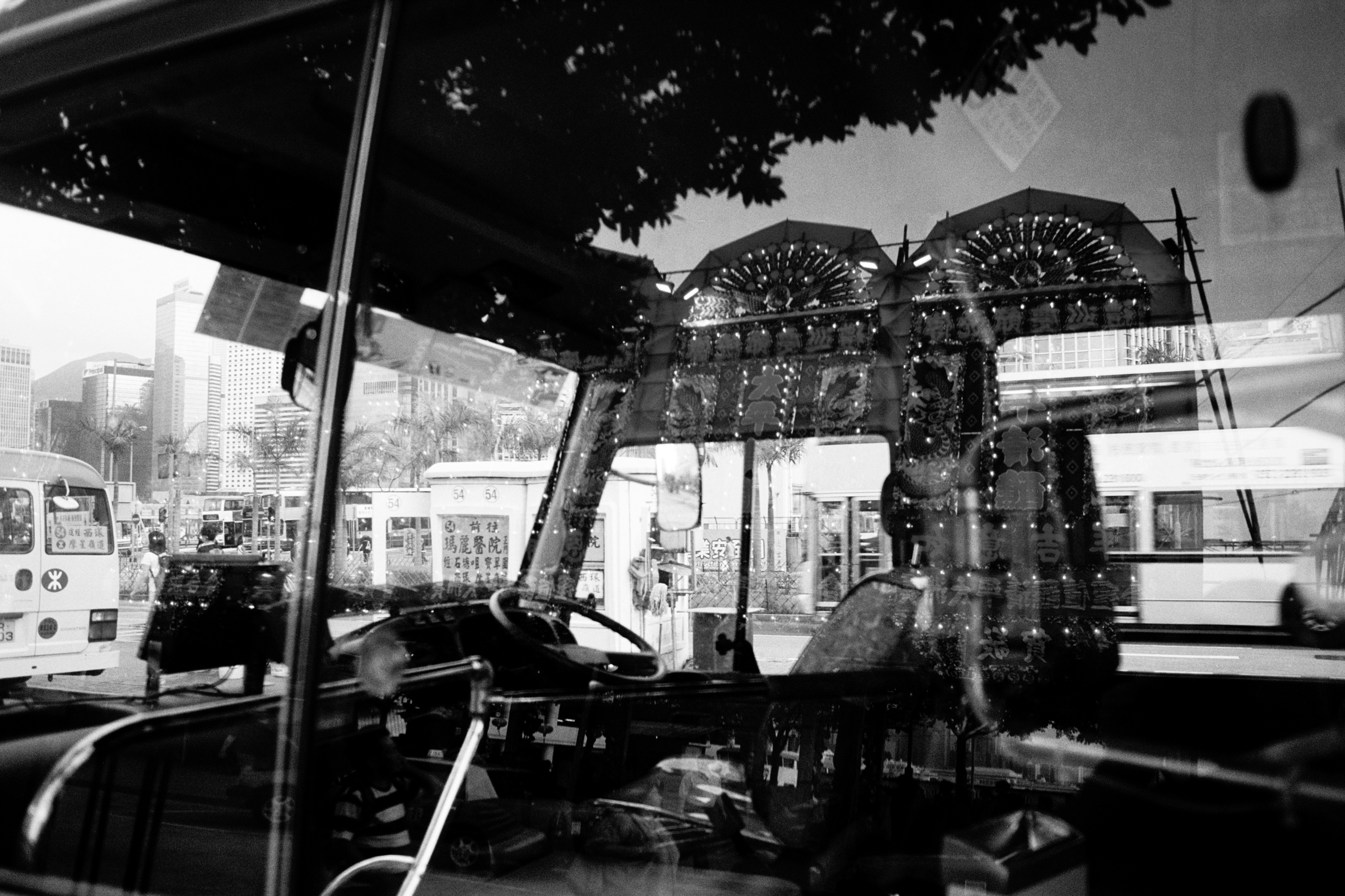 grayscale photo of cars parked near building