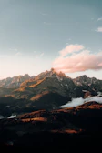 A scenic mountain range captured during a flight at golden hour.