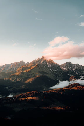 A scenic mountain range captured during a flight at golden hour.