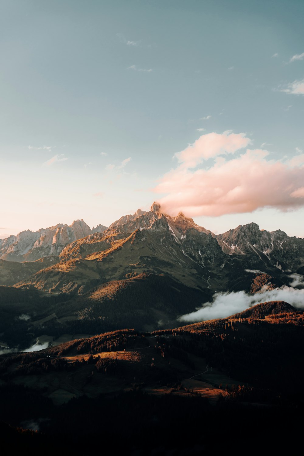 snow covered mountain under cloudy sky during daytime