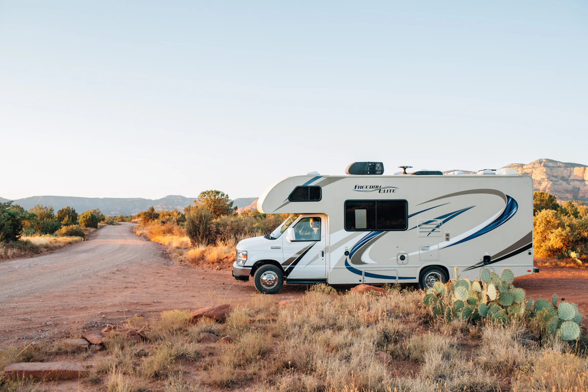 RV parked in a scenic grassy field during the day