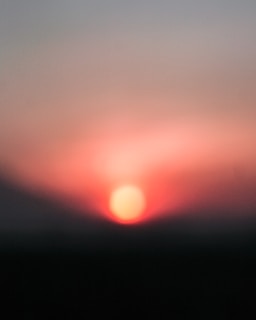 A soft-focus image of a sunrise seen through a window, symbolizing hope and new beginnings.