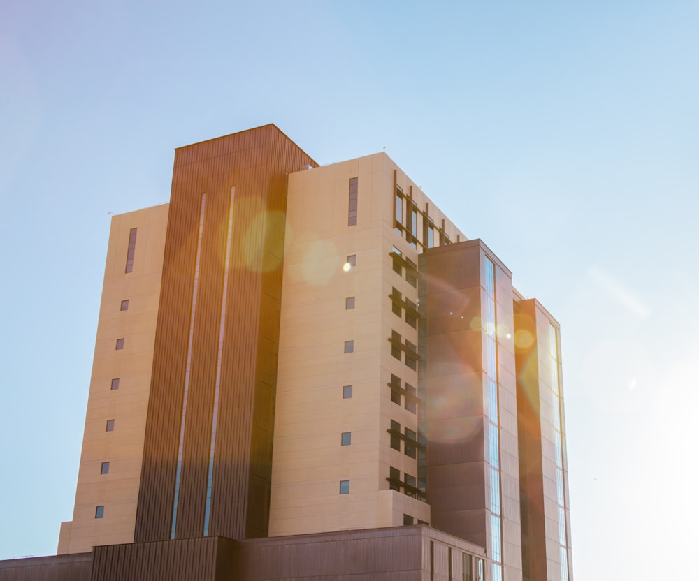 brown and gray concrete building under blue sky during daytime