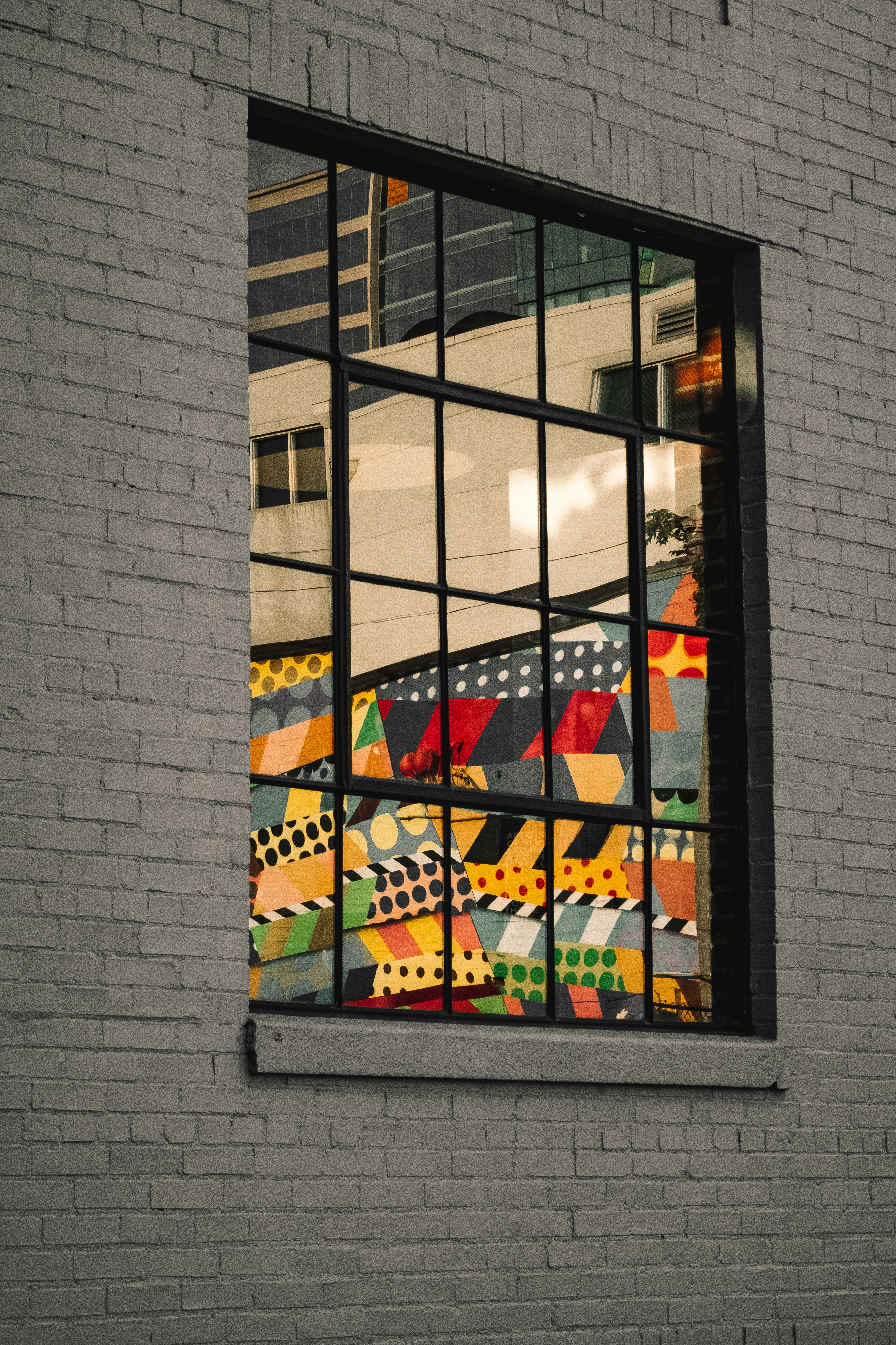 Reflection of a mural in a window in the Gulch, Nashville.