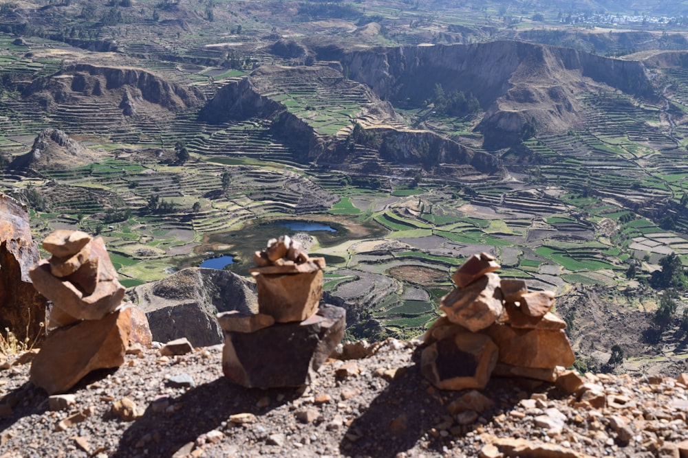 people sitting on rock formation during daytime